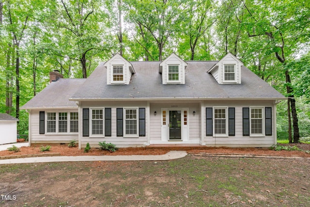 5313 Falkirk Dr, Durham, NC 27712 - cape cod home with a chimney and view of scattered trees