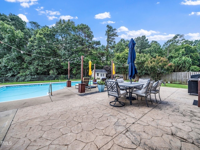 171 Winding Oak Way, Clayton, NC 27520 - view of pool featuring a storage unit, a patio, a fenced backyard, outdoor dining area, and a grill