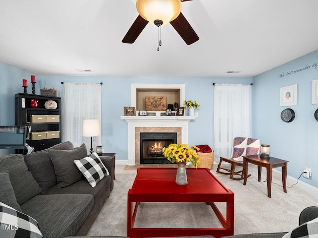 171 Winding Oak Way, Clayton, NC 27520 - living area featuring light carpet, a tiled fireplace, and ceiling fan