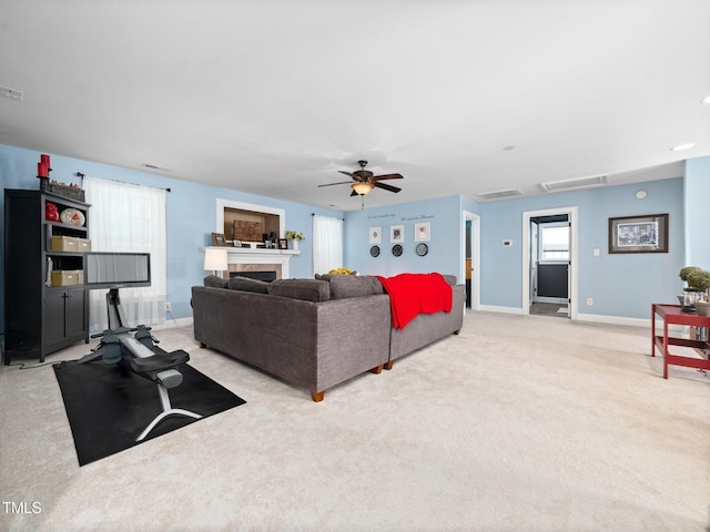 171 Winding Oak Way, Clayton, NC 27520 - carpeted living room with attic access, ceiling fan, and a fireplace