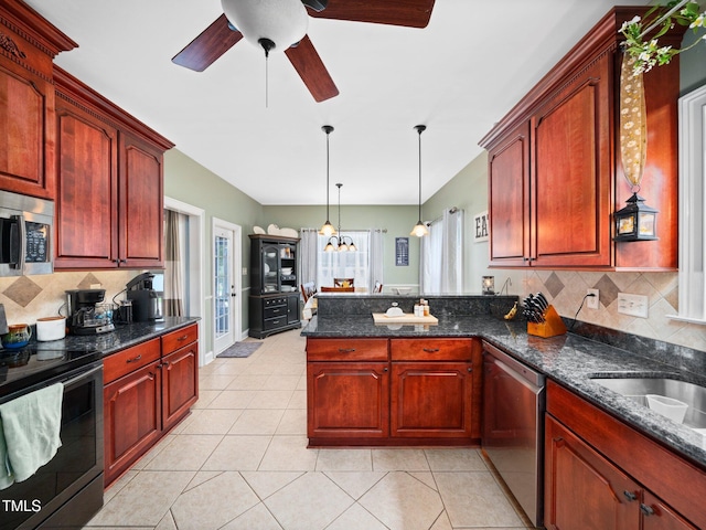 171 Winding Oak Way, Clayton, NC 27520 - kitchen featuring stainless steel appliances, a peninsula, ceiling fan, tasteful backsplash, and hanging light fixtures