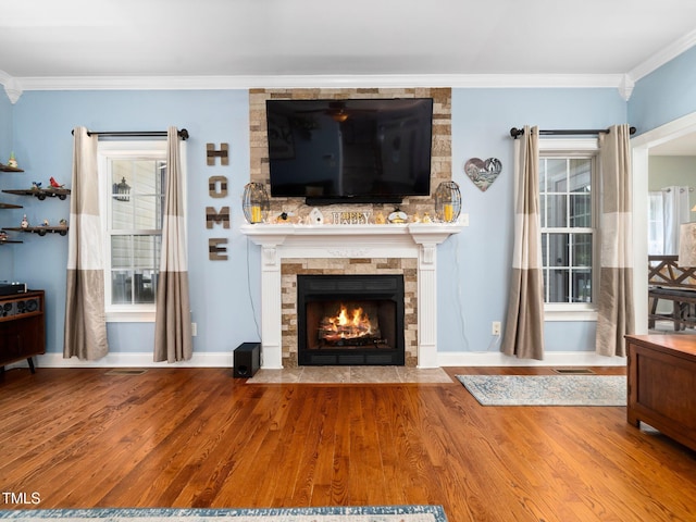 171 Winding Oak Way, Clayton, NC 27520 - living room with crown molding, wood finished floors, and a stone fireplace