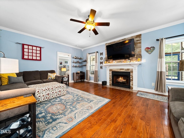 171 Winding Oak Way, Clayton, NC 27520 - living area with ceiling fan, wood finished floors, a stone fireplace, and crown molding