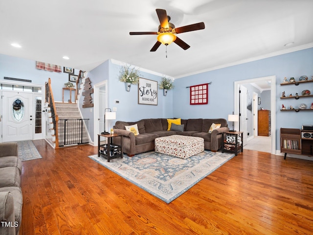 171 Winding Oak Way, Clayton, NC 27520 - living room featuring stairs, wood finished floors, ceiling fan, and ornamental molding