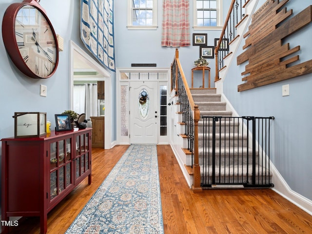 171 Winding Oak Way, Clayton, NC 27520 - foyer featuring stairs, wood finished floors, and a towering ceiling