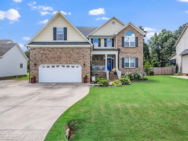 171 Winding Oak Way, Clayton, NC 27520 - traditional home featuring an attached garage, concrete driveway, brick siding, and covered porch