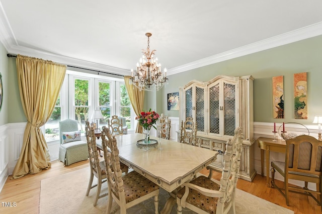 137 Forked Pine Ct, Chapel Hill, NC 27517 - dining area with ornamental molding, a chandelier, light wood finished floors, a decorative wall, and wainscoting