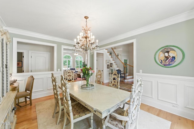 137 Forked Pine Ct, Chapel Hill, NC 27517 - dining space with stairway, a chandelier, crown molding, light wood finished floors, and a decorative wall