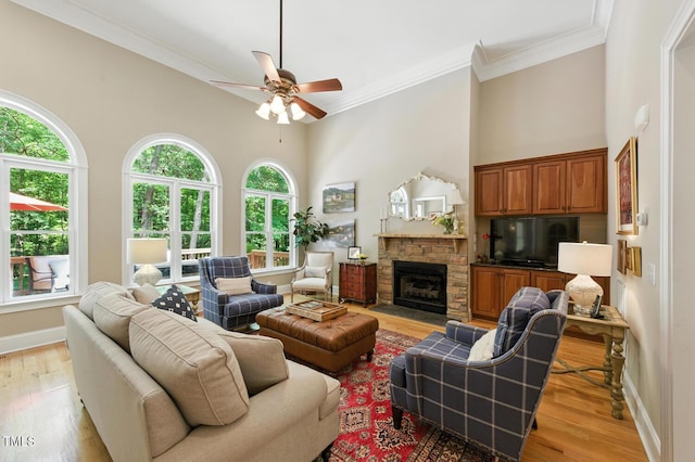 137 Forked Pine Ct, Chapel Hill, NC 27517 - living room with ceiling fan, light wood-style floors, a high ceiling, crown molding, and a stone fireplace