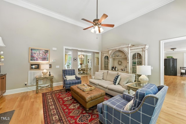 137 Forked Pine Ct, Chapel Hill, NC 27517 - living room with ceiling fan, a high ceiling, crown molding, light wood finished floors, and a chandelier