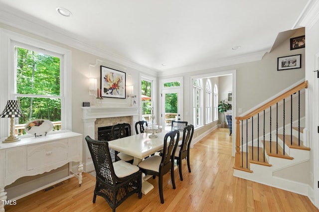 137 Forked Pine Ct, Chapel Hill, NC 27517 - dining room featuring a fireplace, light wood-style flooring, stairs, ornamental molding, and recessed lighting