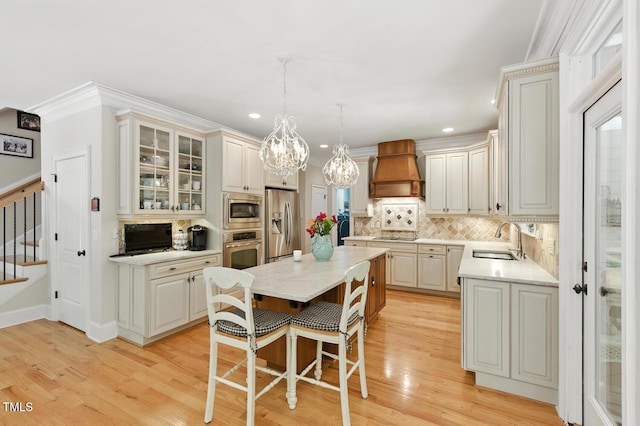 137 Forked Pine Ct, Chapel Hill, NC 27517 - kitchen with backsplash, custom exhaust hood, a center island, appliances with stainless steel finishes, and a kitchen bar