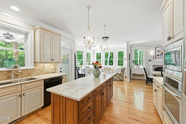 137 Forked Pine Ct, Chapel Hill, NC 27517 - kitchen with a chandelier, a kitchen island, stainless steel appliances, light wood finished floors, and crown molding