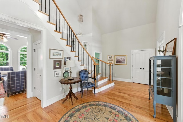 137 Forked Pine Ct, Chapel Hill, NC 27517 - foyer entrance with high vaulted ceiling, stairs, light wood-type flooring, and a ceiling fan