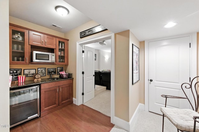 137 Forked Pine Ct, Chapel Hill, NC 27517 - kitchen featuring brown cabinets, beverage cooler, glass insert cabinets, light wood-type flooring, and recessed lighting