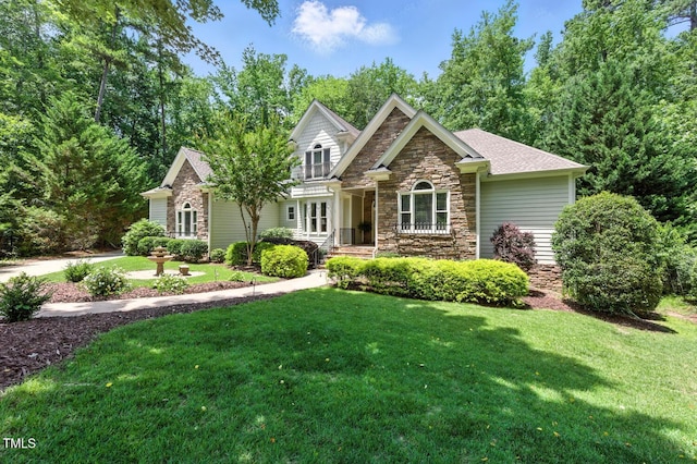 137 Forked Pine Ct, Chapel Hill, NC 27517 - view of front of home featuring stone siding, a front lawn, and roof with shingles