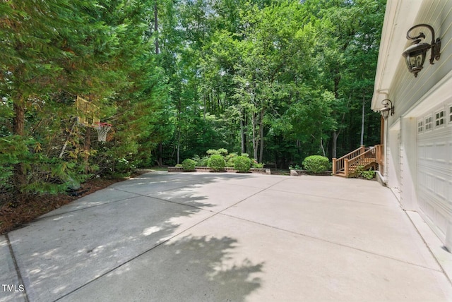 137 Forked Pine Ct, Chapel Hill, NC 27517 - view of patio with a garage, driveway, and a forest view