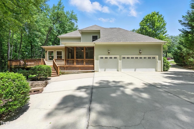 137 Forked Pine Ct, Chapel Hill, NC 27517 - view of front facade featuring a sunroom, roof with shingles, driveway, a garage, and a deck