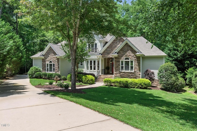 137 Forked Pine Ct, Chapel Hill, NC 27517 - view of front of house featuring stone siding, roof with shingles, a front lawn, and concrete driveway