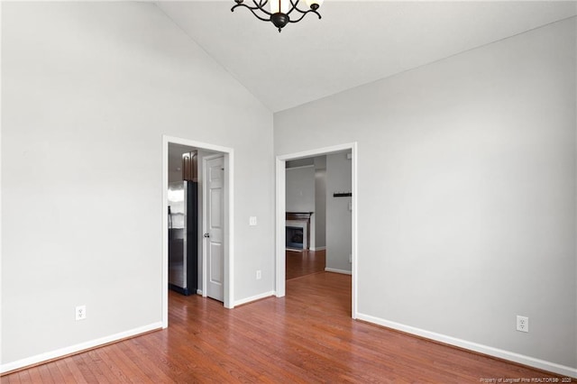 1605 Stanford Ct, Fayetteville, NC 28314 - empty room with a chandelier, high vaulted ceiling, and wood finished floors