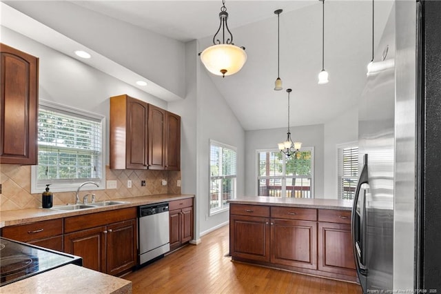 1605 Stanford Ct, Fayetteville, NC 28314 - kitchen with stainless steel appliances, light wood-style flooring, tasteful backsplash, pendant lighting, and light countertops