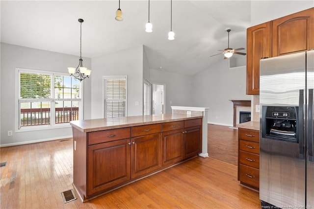 1605 Stanford Ct, Fayetteville, NC 28314 - kitchen with stainless steel refrigerator with ice dispenser, light wood-type flooring, light countertops, ceiling fan, and a chandelier