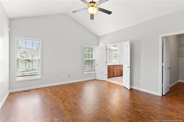 1605 Stanford Ct, Fayetteville, NC 28314 - unfurnished bedroom featuring a walk in closet, wood finished floors, high vaulted ceiling, ensuite bath, and ceiling fan
