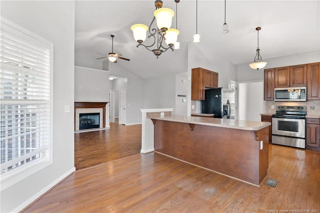 1605 Stanford Ct, Fayetteville, NC 28314 - kitchen with appliances with stainless steel finishes, a ceiling fan, light countertops, tasteful backsplash, and healthy amount of natural light