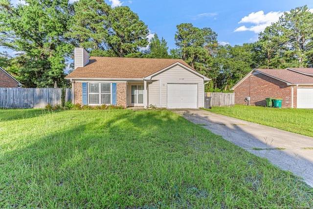 4105 Freedom Ln, Hope Mills, NC 28348 - single story home with an attached garage, concrete driveway, a chimney, and brick siding