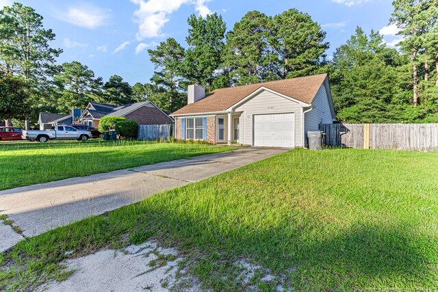 4105 Freedom Ln, Hope Mills, NC 28348 - view of front of home with a garage, a chimney, driveway, and brick siding