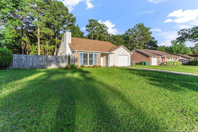 4105 Freedom Ln, Hope Mills, NC 28348 - view of front of home featuring an attached garage, a chimney, and brick siding