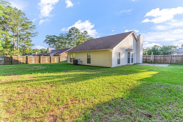4105 Freedom Ln, Hope Mills, NC 28348 - back of house with a chimney, a fenced backyard, and a patio area