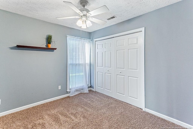 4105 Freedom Ln, Hope Mills, NC 28348 - unfurnished bedroom with carpet floors, a closet, a textured ceiling, and ceiling fan