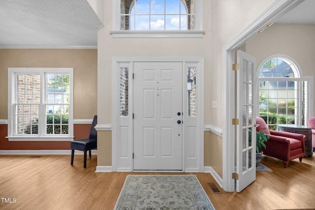 3608 Smoky Chestnut Ln, Raleigh, NC 27615 - entryway featuring light wood-style floors, healthy amount of natural light, and ornamental molding