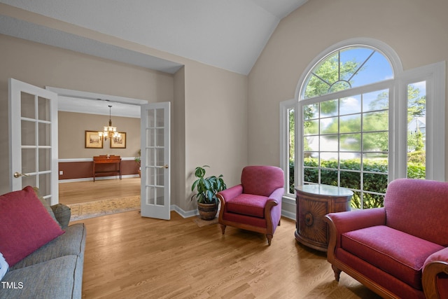 3608 Smoky Chestnut Ln, Raleigh, NC 27615 - sitting room featuring french doors, a chandelier, light wood-type flooring, and lofted ceiling