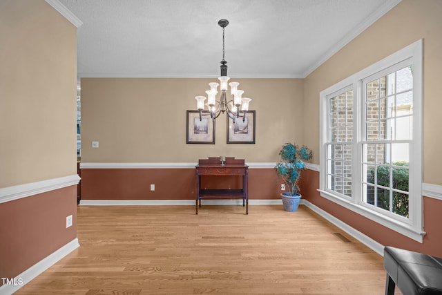 3608 Smoky Chestnut Ln, Raleigh, NC 27615 - dining area featuring a chandelier, light wood-type flooring, and crown molding