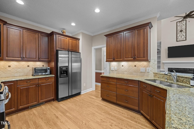 3608 Smoky Chestnut Ln, Raleigh, NC 27615 - kitchen with stainless steel appliances, light wood finished floors, light stone countertops, recessed lighting, and backsplash