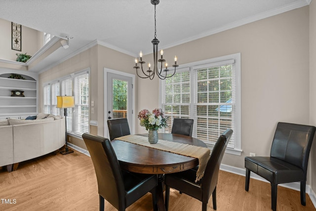 3608 Smoky Chestnut Ln, Raleigh, NC 27615 - dining area with ornamental molding, a chandelier, light wood-style floors, and built in shelves