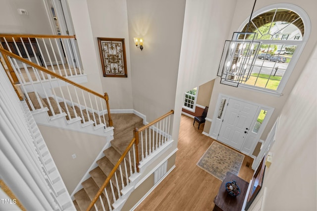 3608 Smoky Chestnut Ln, Raleigh, NC 27615 - entryway featuring plenty of natural light, stairway, wood finished floors, and a high ceiling