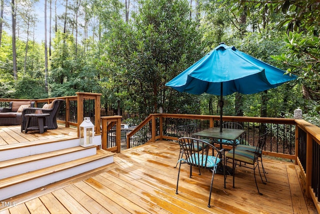 3608 Smoky Chestnut Ln, Raleigh, NC 27615 - wooden deck featuring outdoor dining area, view of wooded area, and an outdoor hangout area