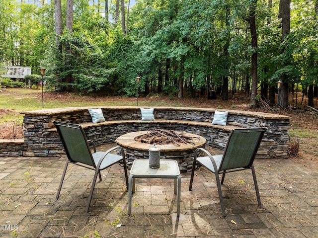 3608 Smoky Chestnut Ln, Raleigh, NC 27615 - view of patio with an outdoor fire pit and view of wooded area