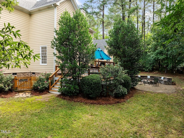 3608 Smoky Chestnut Ln, Raleigh, NC 27615 - view of grassy yard with a wooden deck, a patio, and a fire pit