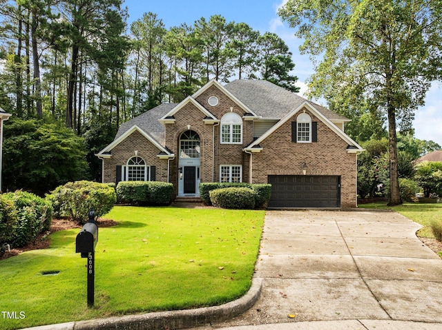 3608 Smoky Chestnut Ln, Raleigh, NC 27615 - view of front facade with an attached garage, driveway, brick siding, and a front yard
