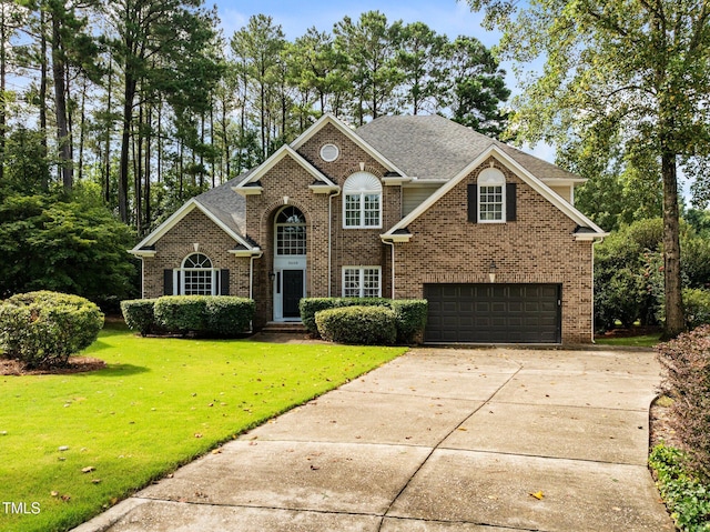 3608 Smoky Chestnut Ln, Raleigh, NC 27615 - view of front of house featuring a garage, brick siding, driveway, a front yard, and a shingled roof