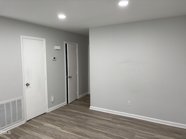 1405 Highview Ct, Raleigh, NC 27606 - spare room featuring recessed lighting and dark wood-type flooring