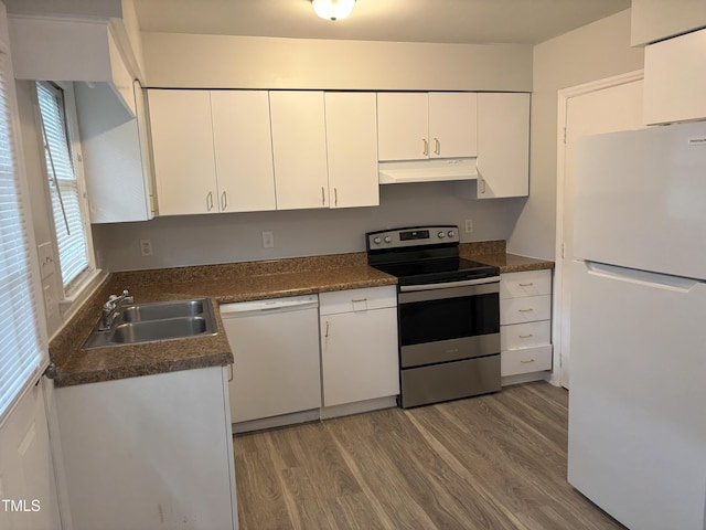 1405 Highview Ct, Raleigh, NC 27606 - kitchen featuring white appliances, under cabinet range hood, wood finished floors, white cabinets, and dark countertops