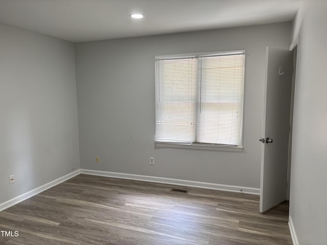 1405 Highview Ct, Raleigh, NC 27606 - spare room with wood finished floors and recessed lighting