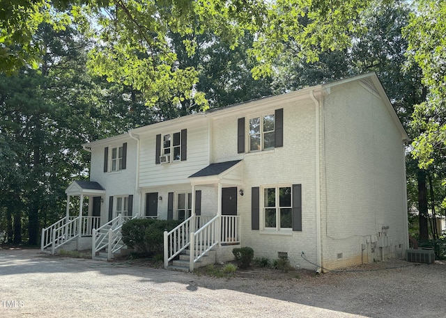1405 Highview Ct, Raleigh, NC 27606 - colonial-style house with crawl space, brick siding, and view of scattered trees