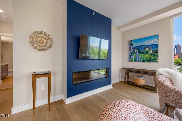 214 Hunt St Unit 503, Durham, NC 27701 - living room featuring wood finished floors, a glass covered fireplace, and recessed lighting