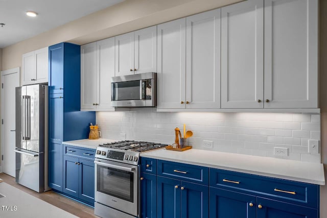 214 Hunt St Unit 503, Durham, NC 27701 - kitchen with stainless steel appliances, blue cabinets, light countertops, and backsplash
